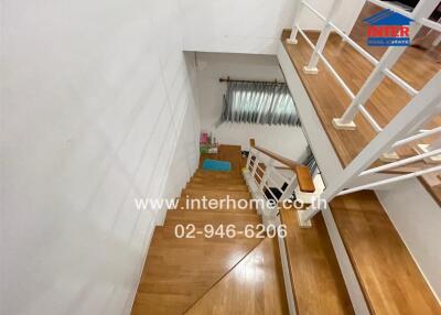 Wooden staircase with railing and window