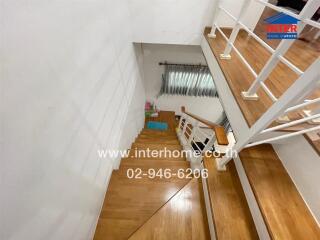 Wooden staircase with railing and window