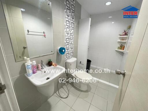 Modern bathroom with white fixtures and ample lighting