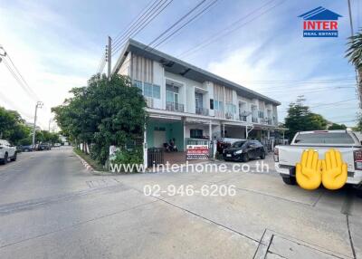 Two-story townhouse with a modern exterior and a small front yard