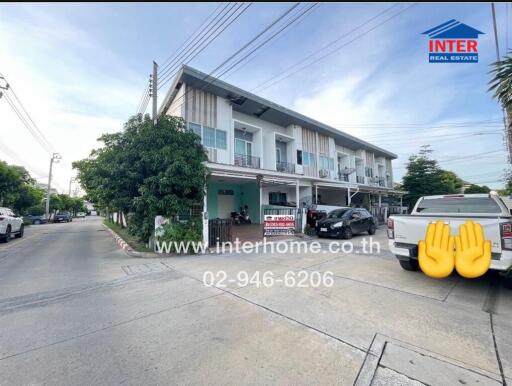 Two-story townhouse with a modern exterior and a small front yard