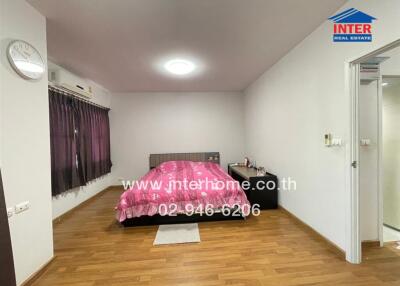 Modern bedroom with wooden floor and purple curtains