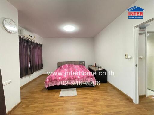 Modern bedroom with wooden floor and purple curtains