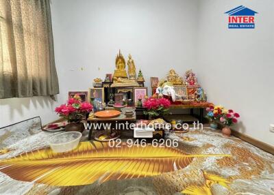 Decorated room with religious items and flowers