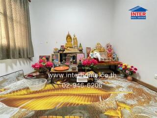 Decorated room with religious items and flowers