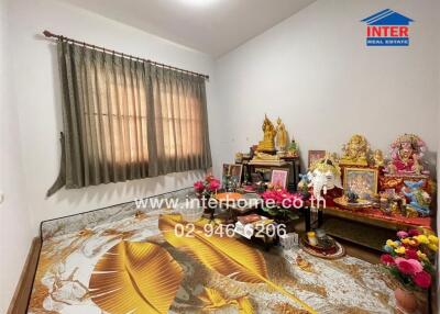 Bedroom with decorative figurines and ornate bedspread