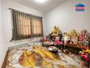 Bedroom with decorative figurines and ornate bedspread