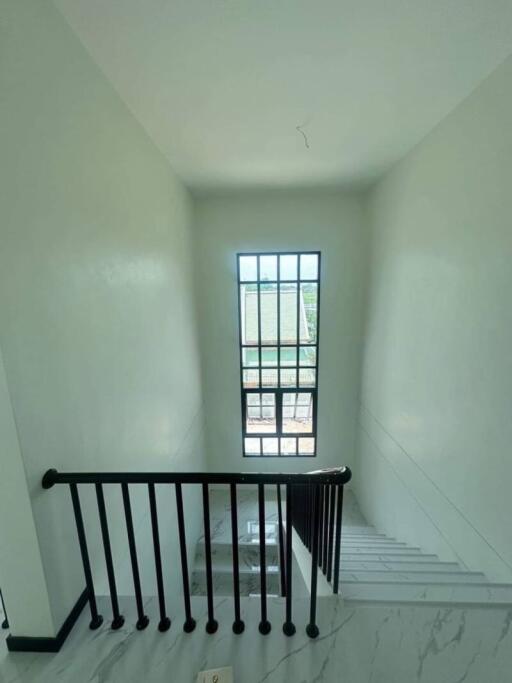 Bright and clean staircase with large window