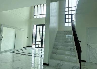 Modern living space with large windows and marble staircase