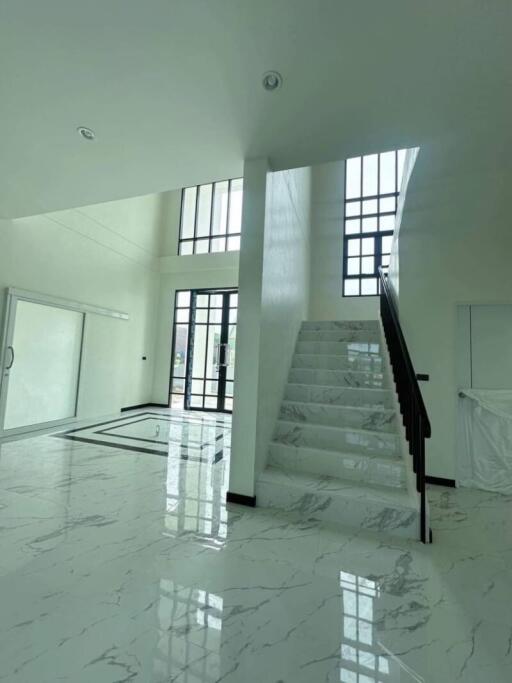 Modern living space with large windows and marble staircase