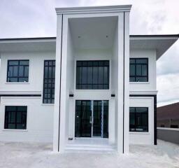 Modern two-story house exterior with large windows