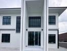 Modern two-story house exterior with large windows