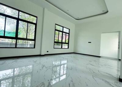 Spacious living room with marble flooring and large windows