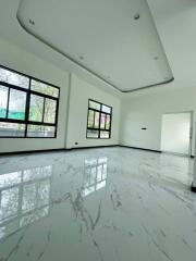 Spacious living room with marble flooring and large windows