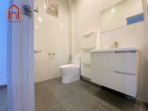 Modern bathroom with white fixtures and gray tile floor