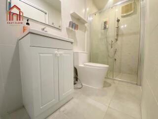 Modern bathroom with white fixtures and glass shower