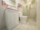 Modern bathroom with white fixtures and glass shower