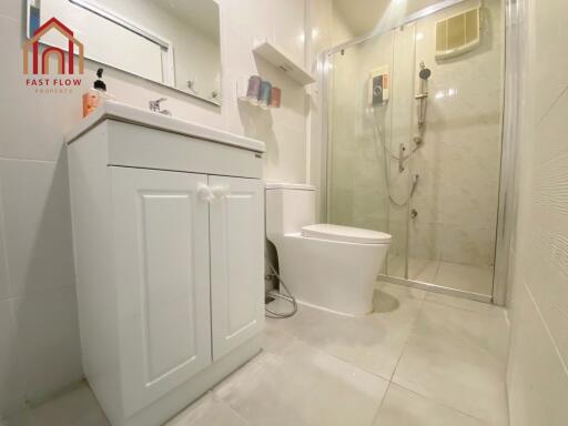 Modern bathroom with white fixtures and glass shower