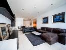 Modern living room with leather sofas and wall art