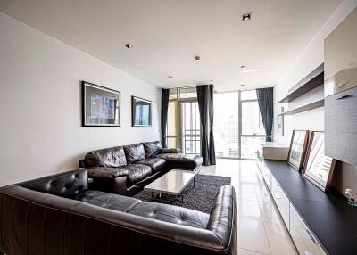 Modern living room with leather sofas and large windows