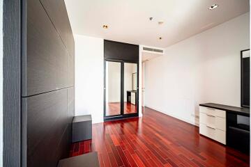 Modern bedroom with wood flooring and built-in closet