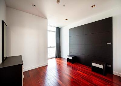 Modern bedroom with hardwood floors and large window