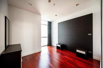 Modern bedroom with hardwood floors and large window