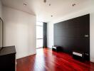 Modern bedroom with hardwood floors and large window