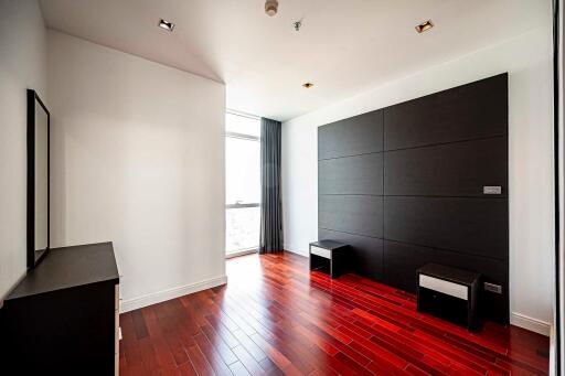 Modern bedroom with hardwood floors and large window