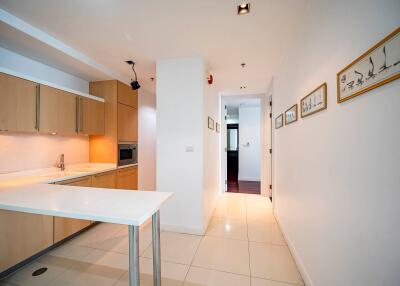 Modern kitchen with white countertops and wooden cabinets