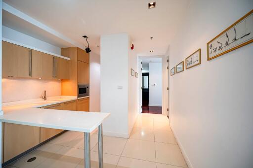 Modern kitchen with white countertops and wooden cabinets