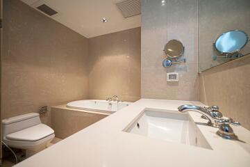 Modern bathroom with bathtub, sink, and toilet