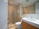 Modern bathroom with glass shower enclosure and large mirror