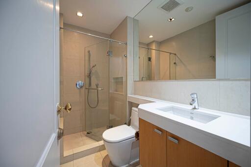 Modern bathroom with glass shower enclosure and large mirror