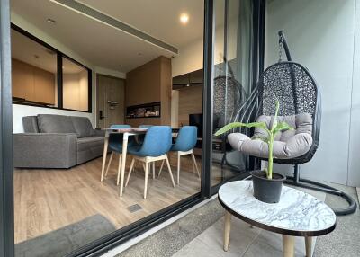 Modern open living room with dining area and balcony