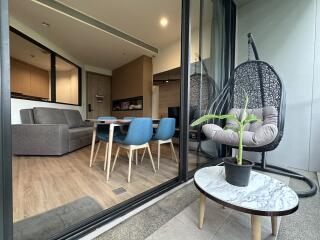 Modern open living room with dining area and balcony