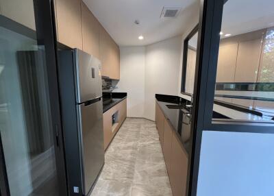 Modern kitchen with stainless steel appliances and reflective surfaces