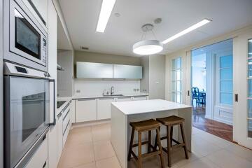 Modern white kitchen with island and built-in appliances