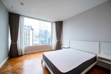 Modern bedroom with large windows and city view