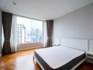 Modern bedroom with large windows and city view