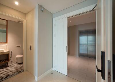 Entryway with a glimpse into the bathroom and adjacent rooms