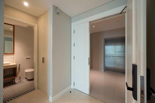 Entryway with a glimpse into the bathroom and adjacent rooms