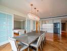 Modern dining area with adjacent open kitchen and bedroom