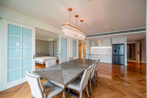 Modern dining area with adjacent open kitchen and bedroom