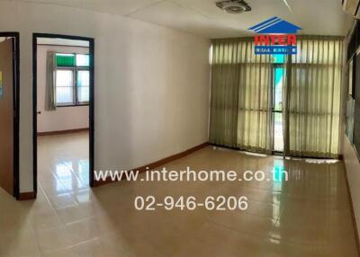 Main living space with glass door and tiled floor