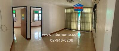 Main living space with glass door and tiled floor