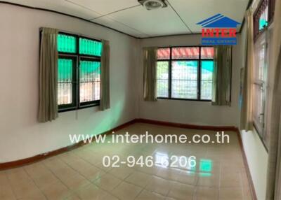 Bedroom with large windows and tiled floor