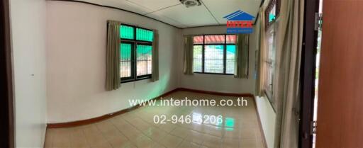 Bedroom with large windows and tiled floor