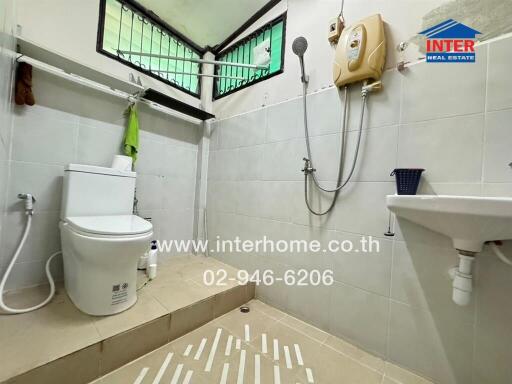 Bathroom with shower, toilet, and sink