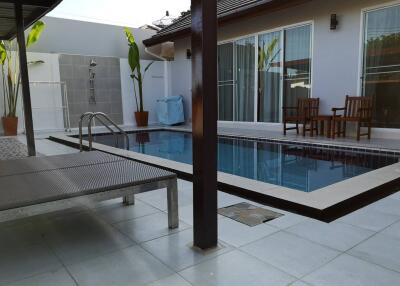 Outdoor pool area with poolside seating and modern amenities